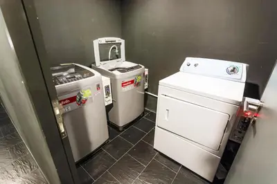 a laundry room with two washers and a dryer at Holiday apartment at The Deck by Lofty in Patong Beach
