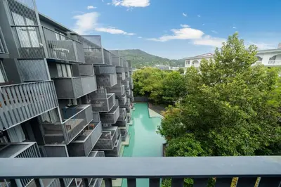 an apartment building with balconies and a river at Holiday apartment at The Deck by Lofty in Patong Beach