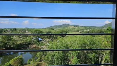 a view of a river from a window at Квартира in Ban Mai Salae