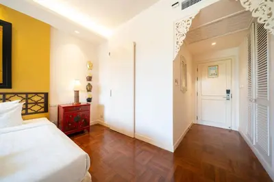a bedroom with a white bed and a red table at Stylish Thai 2BR Condo Pool & Golf with Balcony in Laguna Phuket