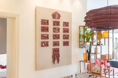 a wall with a bunch of pictures on it at Stylish Thai 2BR Condo Pool & Golf with Balcony in Laguna Phuket
