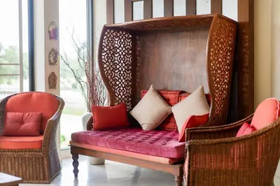a room with two chairs and a couch with pillows at Stylish Thai 2BR Condo Pool & Golf with Balcony in Laguna Phuket