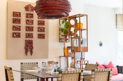 a dining room with a table and chairs at Stylish Thai 2BR Condo Pool & Golf with Balcony in Laguna Phuket