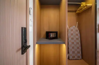 a room with a closet with a clock on a shelf at Stylish Forest View Studio Near Naithon Beach 1528 in Nai Thon Beach