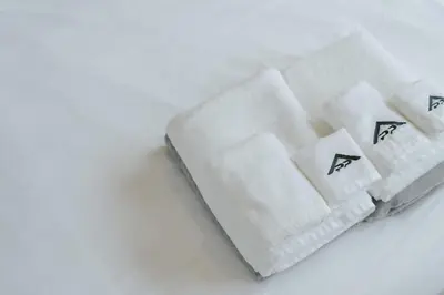 two white towels sitting on top of a table at Stylish Forest View Studio Near Naithon Beach 1528 in Nai Thon Beach