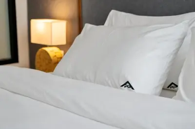 a close up of two beds with white sheets and pillows at Stylish Forest View Studio Near Naithon Beach 1528 in Nai Thon Beach