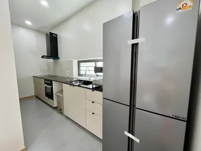 a kitchen with a stainless steel refrigerator at Bay Sand Villa by Jai House Phuket in Ban Klang