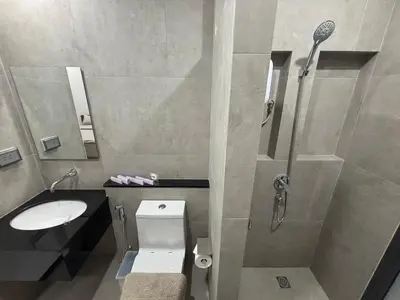 a bathroom with a shower and a toilet and a sink at Bay Sand Villa by Jai House Phuket in Ban Klang