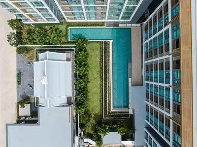 an aerial view of a building with a pool at Suite Luna Pool and Gym Access The Ozone Condo in Bang Tao Beach