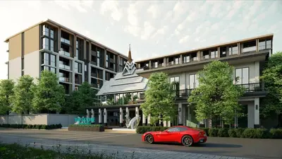 a red car parked in front of a building at Suite Luna Pool and Gym Access The Ozone Condo in Bang Tao Beach