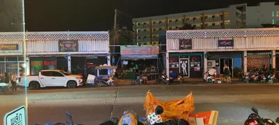 a city street at night with cars and buildings at Sereneburi Patong Hotel in Patong Beach