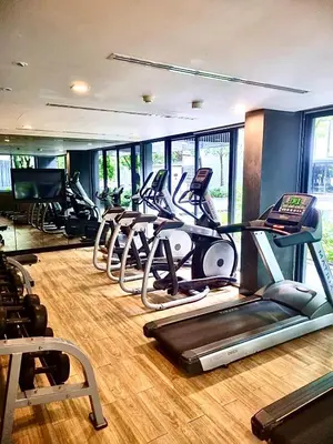 a gym with several treadmills and elliptical machines at The Deck Patong in Patong Beach