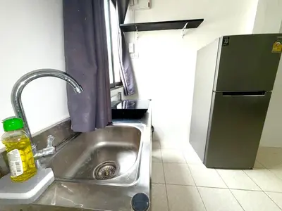 a kitchen with a sink and a refrigerator at Patong Canal Villa 108 in Patong Beach