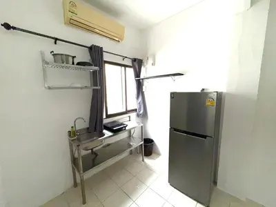 a kitchen with a sink and a refrigerator at Patong Canal Villa 108 in Patong Beach