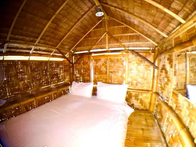 a room with a bed in a bamboo house at Patong Canal House 1 in Patong Beach
