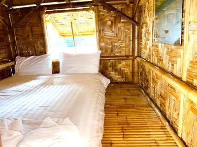 a bedroom with a bed in a wooden room at Patong Canal House 1 in Patong Beach