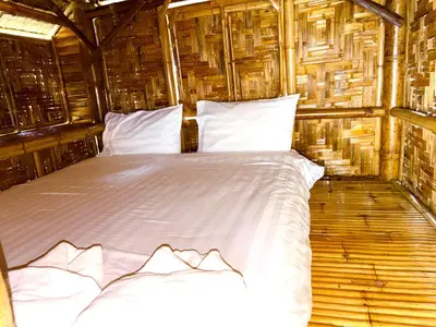 a bedroom with a white bed in a wooden room at Patong Canal House 1 in Patong Beach