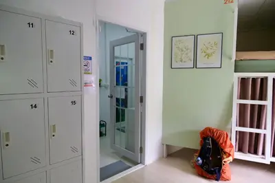 a room with a hallway with white cabinets and a mirror at Sweed Dee Love Hostel in Phi Phi Don