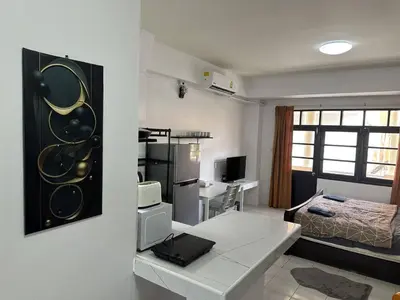 a small room with a bed and a desk in it at Bestin Karon1 - 1 min from the beach, pet friendly TF in Karon Beach