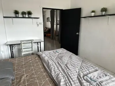 a bedroom with a bed and a table and a desk at Bestin Karon1 - 1 min from the beach, pet friendly TF in Karon Beach