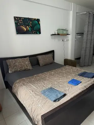 a bedroom with a bed with two towels on it at Bestin Karon1 - 1 min from the beach, pet friendly TF in Karon Beach