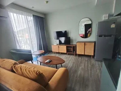 a living room with a couch and a mirror at The Deck Condo Patong Mountain View1 in Patong Beach