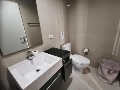 a bathroom with a white sink and a toilet at The Deck Condo Patong Mountain View1 in Patong Beach