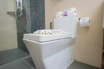 a bathroom with a toilet with a sink on it at Beachfront Family Pool 2 Bed Room Patong Phuket in Patong Beach