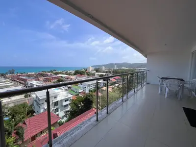a balcony with a table and a view of a city at Sunset Plaza Karon Seaview in Karon Beach