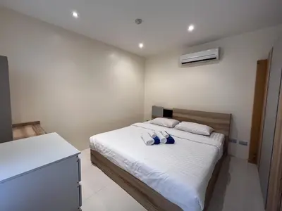 a bedroom with a bed with two pillows on it at Sunset Plaza Karon Seaview in Karon Beach