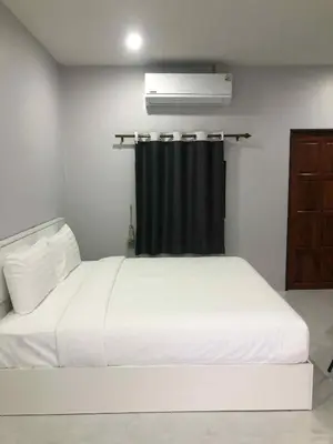 a white bed in a room with a black curtain at Borrii House โบ ลี่ เฮาท์ in Layan Beach