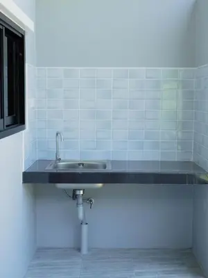 a sink in a bathroom with blue tiles at Borrii House โบ ลี่ เฮาท์ in Layan Beach