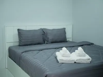 a bed with two pairs of white shoes on it at Borrii House โบ ลี่ เฮาท์ in Layan Beach