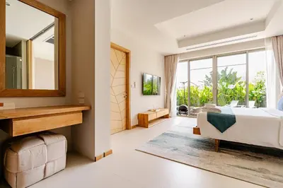 a bedroom with a bed and a mirror at Tropical Family Pool Villa - Bang Tao in Laguna Phuket