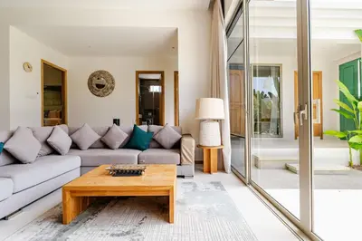 a living room with a couch and a coffee table at Tropical Family Pool Villa - Bang Tao in Laguna Phuket