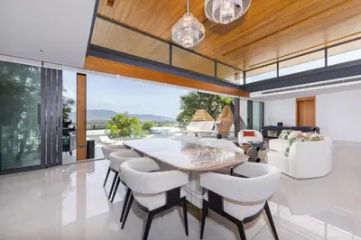 a dining room with a table and chairs at Villa Zavaya 360° View Luxury Retreat With Pool in Layan Beach