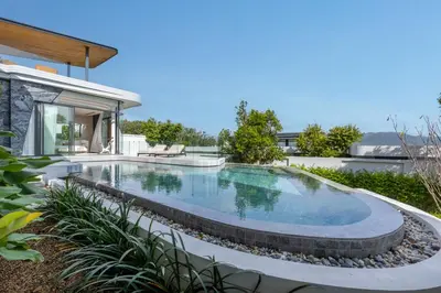 a swimming pool in the backyard of a house at Villa Zavaya 360° View Luxury Retreat With Pool in Layan Beach