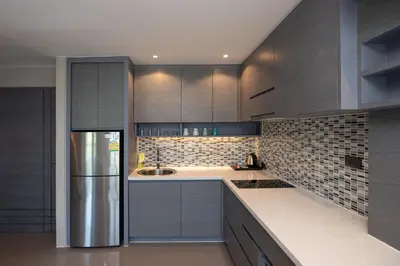 a kitchen with gray cabinets and a stainless steel refrigerator at Tropical Kamala Pool View 1 BR CTG B206 in Kamala Beach