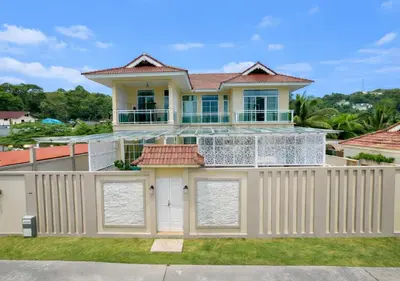 a house with a white fence at Kamala Beach Phuket - 4BR Private Luxury Pool Villa with Maid in Kamala Beach