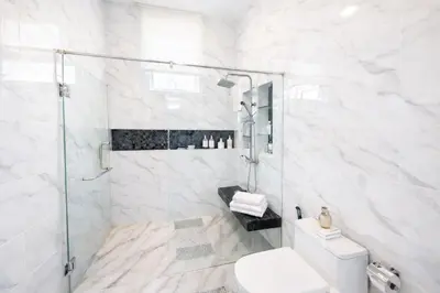 a white bathroom with a shower and a toilet at Kamala Beach Phuket - 4BR Private Luxury Pool Villa with Maid in Kamala Beach