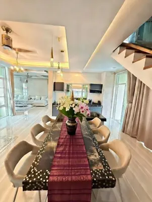 a living room with a long table and chairs at Kamala Beach Phuket - 4BR Private Luxury Pool Villa with Maid in Kamala Beach