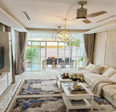 a living room with a couch and a table at Kamala Beach Phuket - 4BR Private Luxury Pool Villa with Maid in Kamala Beach