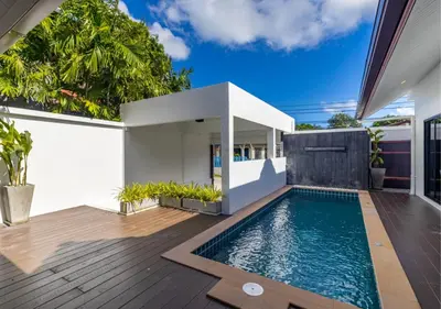 a swimming pool in the backyard of a house at Villa Junia - Quiet 3-bedroom Pool Villa in Ban Saiyuan (1)