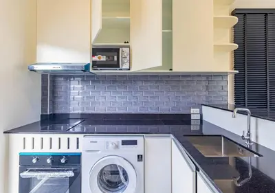 a kitchen with a washer and dryer on a counter at Villa Junia - Quiet 3-bedroom Pool Villa in Ban Saiyuan (1)
