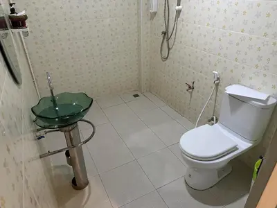 a small bathroom with a toilet and a sink at Nankanok Resort in Ko Yao Noi