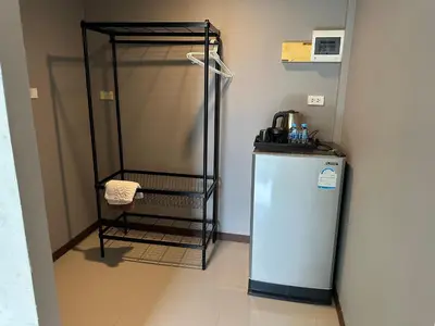 a small refrigerator in a room with a microwave at Nankanok Resort in Ko Yao Noi