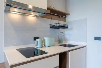 a kitchen with a sink and a counter top at Space Cherngtalay Condo in Elegant Bang Tao in Ban Thalat Choeng Thale