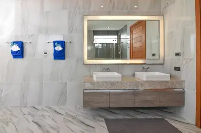 a bathroom with two sinks and a mirror at Breeze Villa - Luxury Relaxation in Phuket in Ban Thalat Choeng Thale