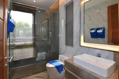 a bathroom with a sink and a shower and a toilet at Breeze Villa - Luxury Relaxation in Phuket in Ban Thalat Choeng Thale