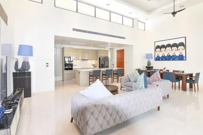 a living room with a couch and a table at Breeze Villa - Luxury Relaxation in Phuket in Ban Thalat Choeng Thale
